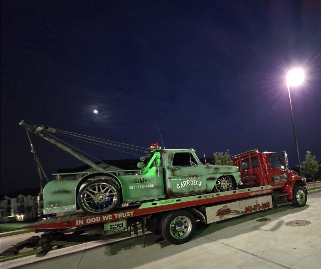 Nighttime flatbed towing service in Palestine TX hauling car