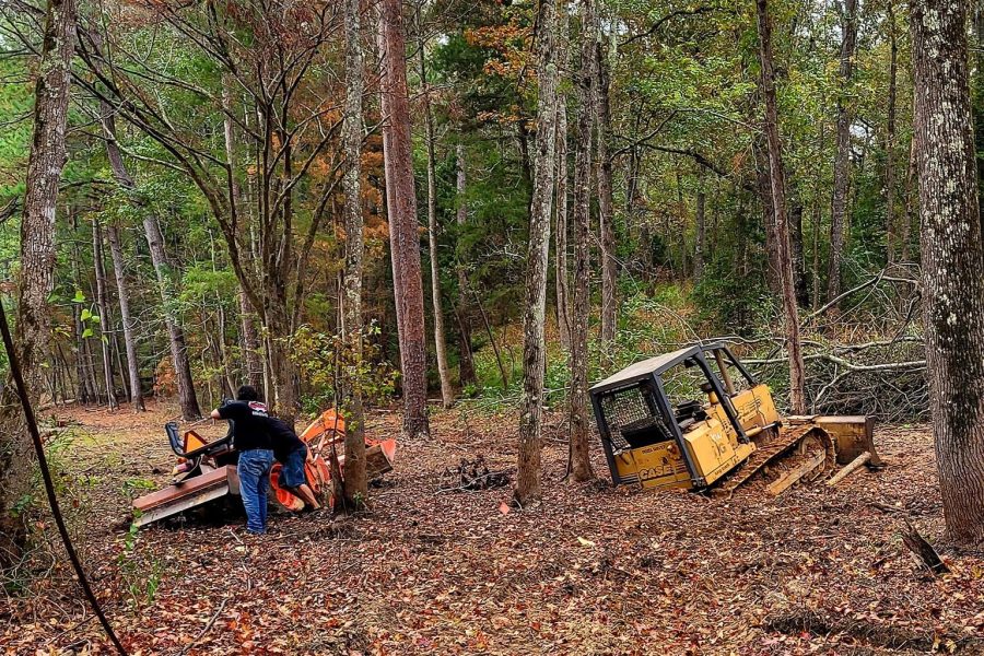 Vehicle recovery service in Palestine TX pulling car from wooded area